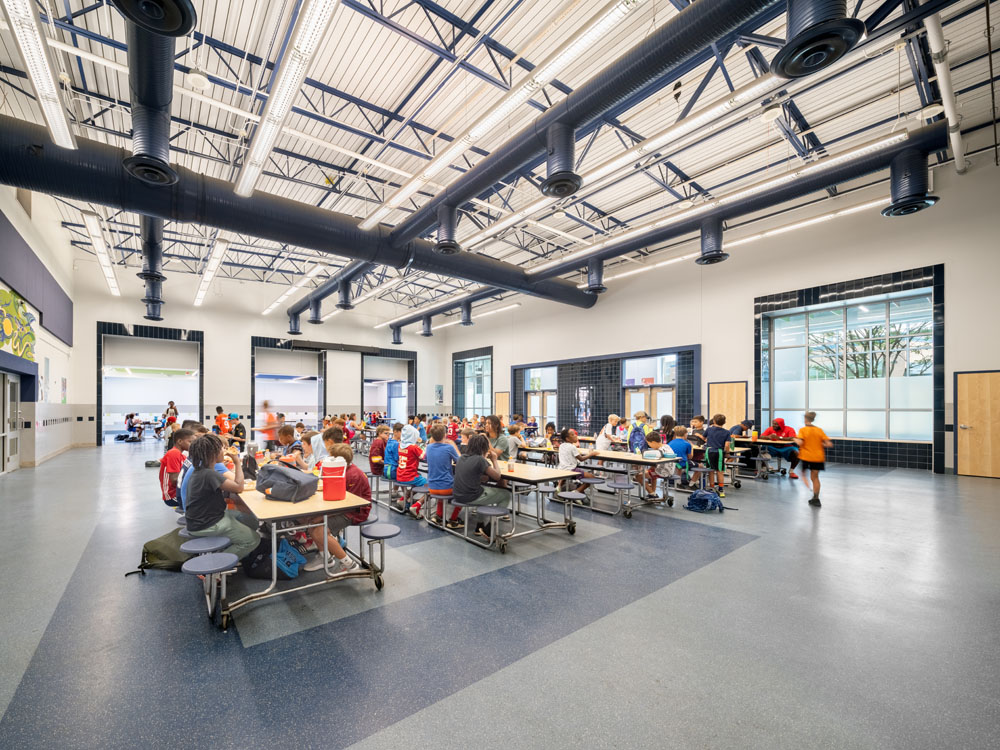 Modern cafeteria design with high ceilings.